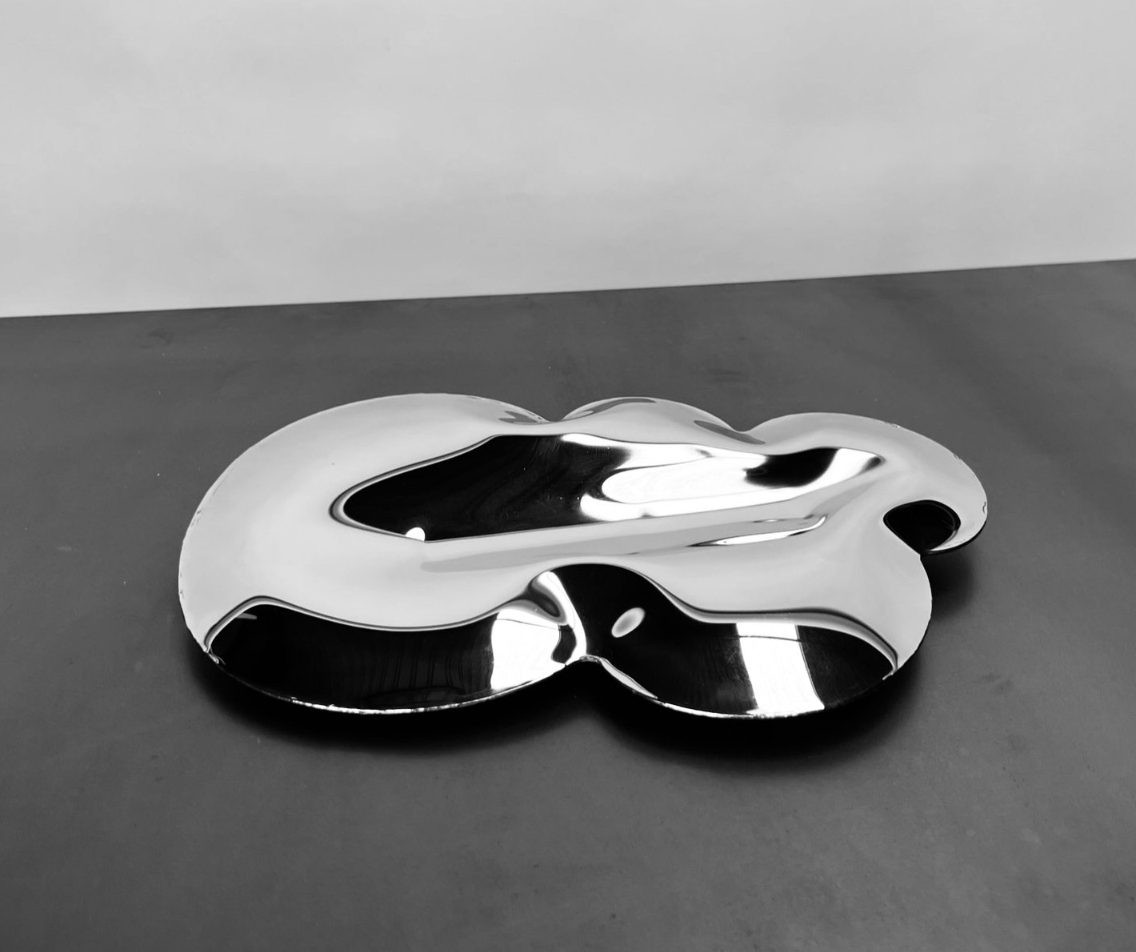 Dynamic reflective burnished steel sculpture