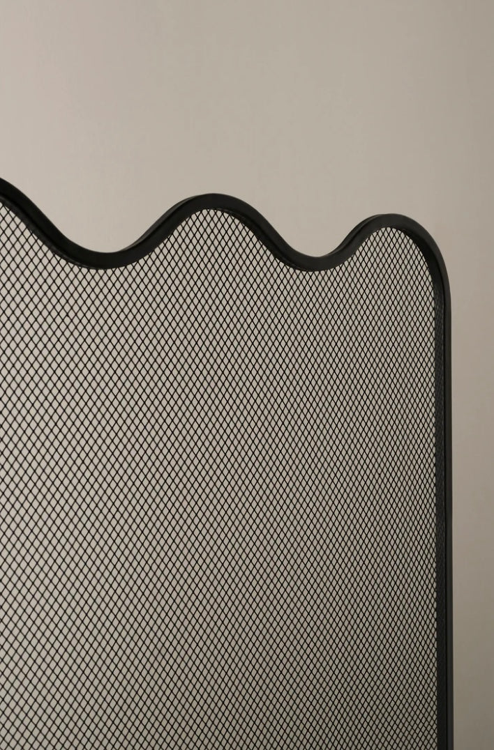 Modern sculptural black fire screen with wavy design