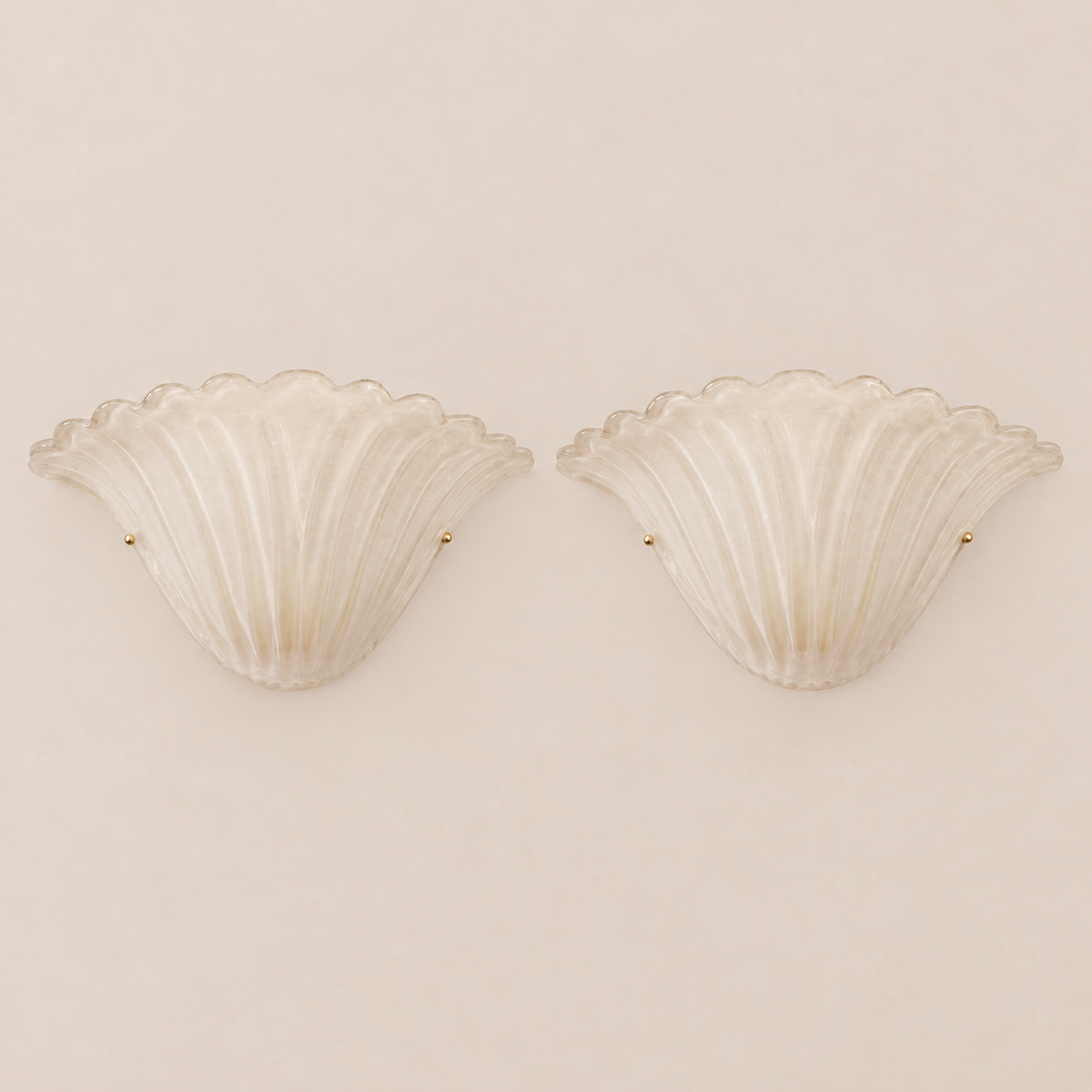 Pair of alabaster fan-shaped Murano glass wall sconces on stone background