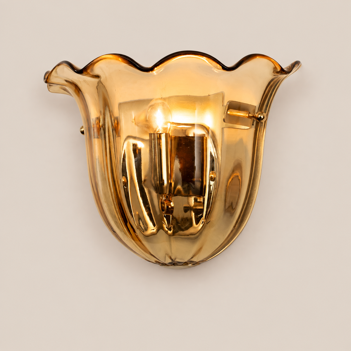 Amber Murano glass wall sconce on stone background