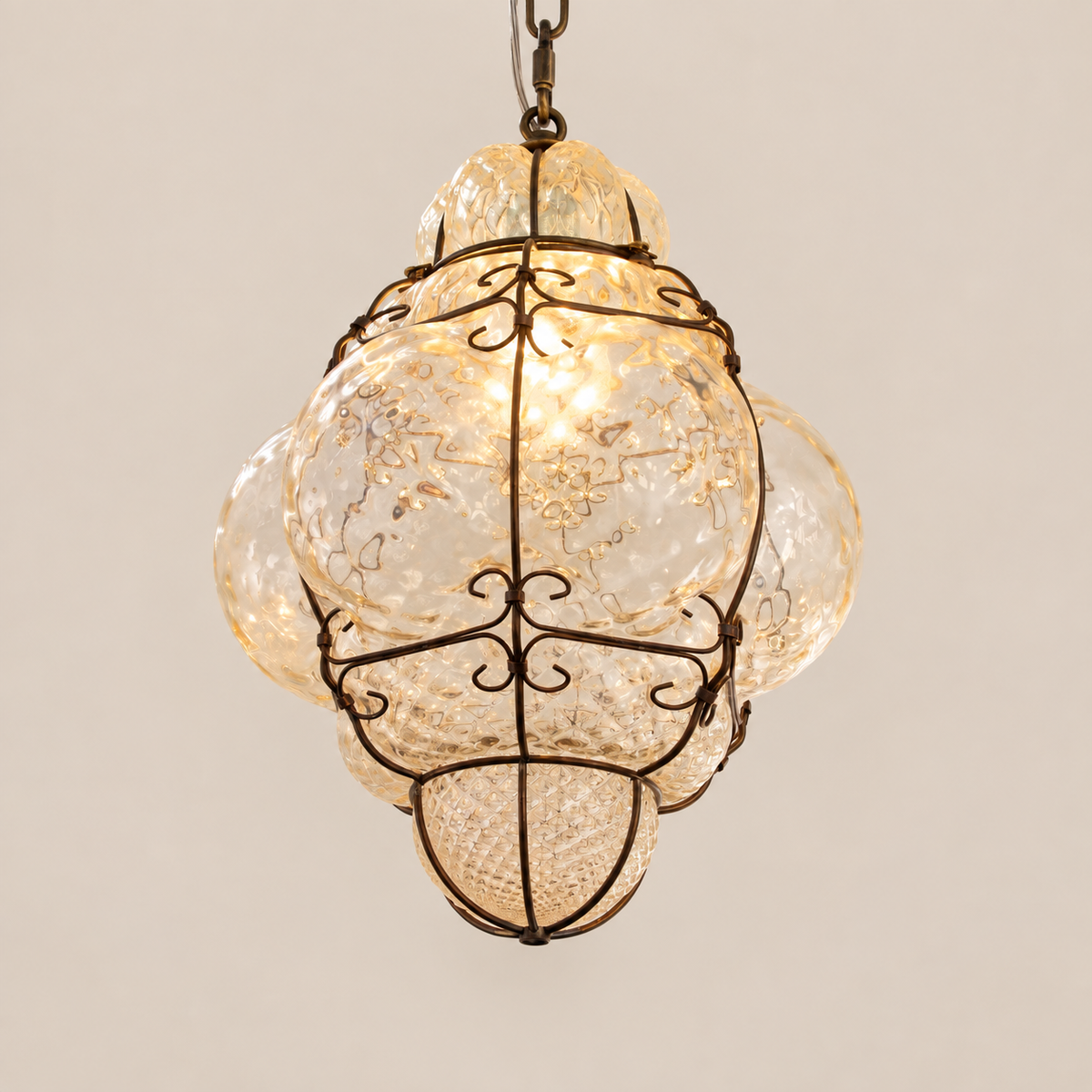 Champagne Murano glass lantern pendant on stone background