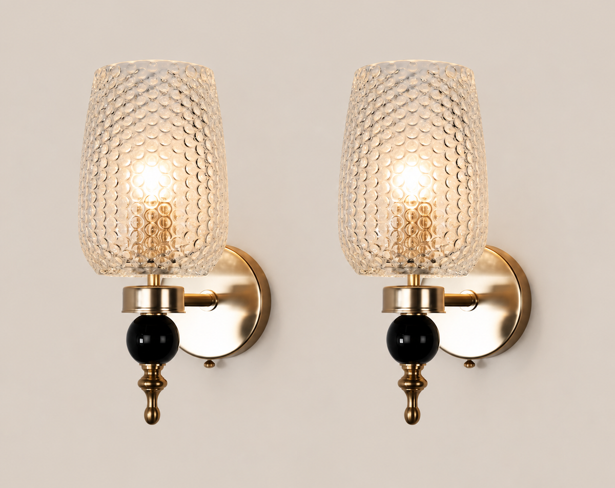 Black and gold Deco Murano sconce pair on warm stone