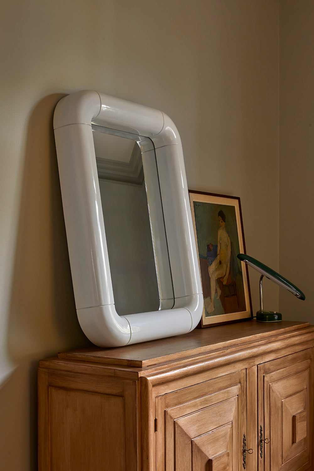 Dora Gloss Mirror Creme styled on cabinet