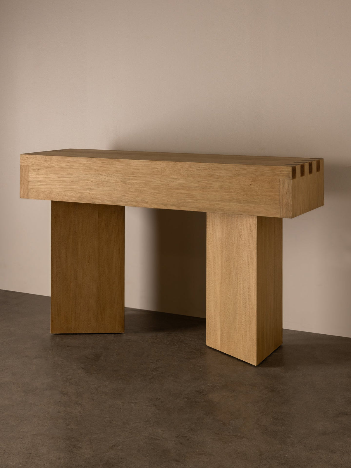 Dovetail Console oak on stone-toned studio background