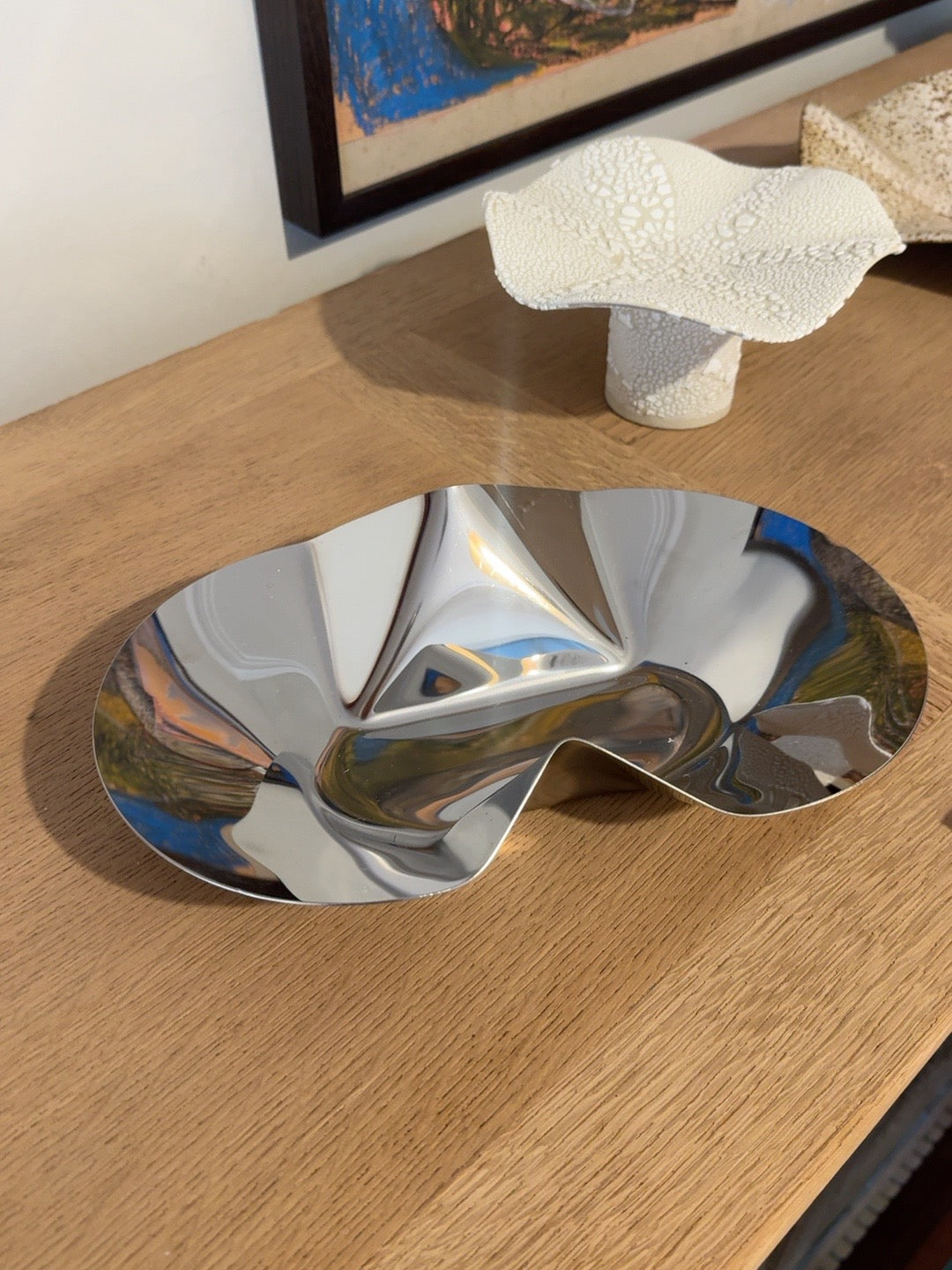 Flats by Duzi Objects, sculptural polished metal dish on oak table