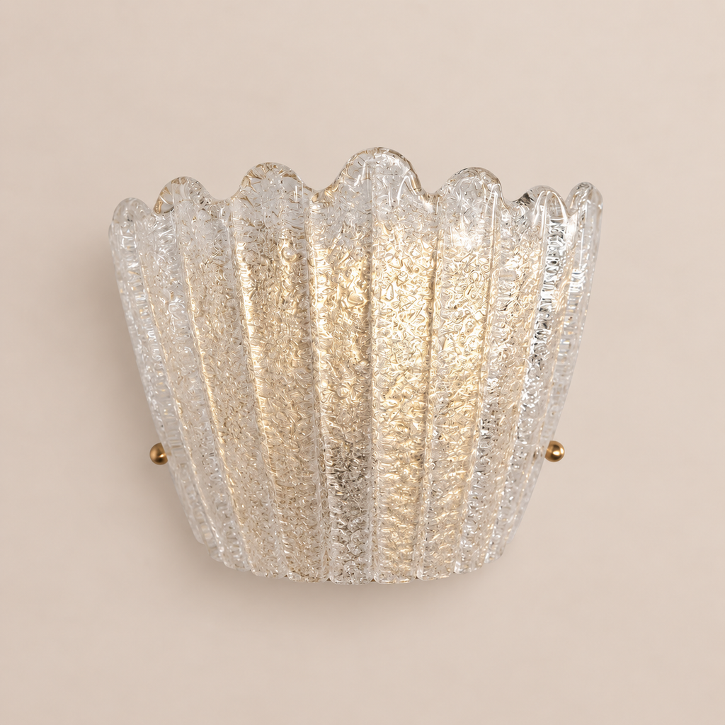 Scalloped clear Murano glass wall sconce on stone background