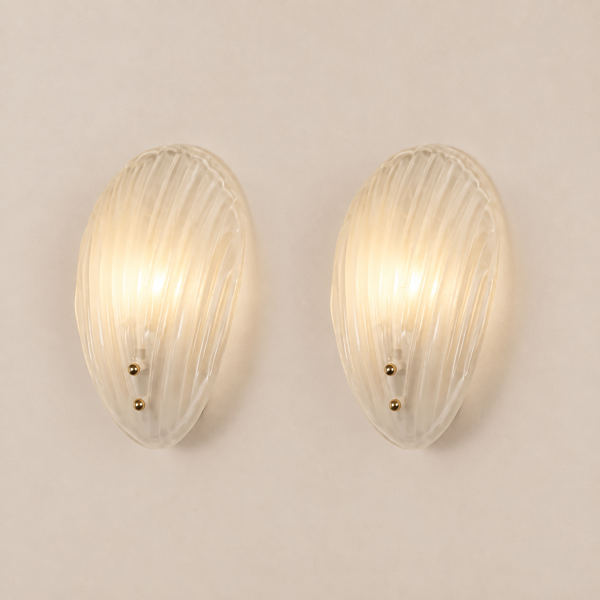 Pair of shell Murano glass wall sconces on stone background